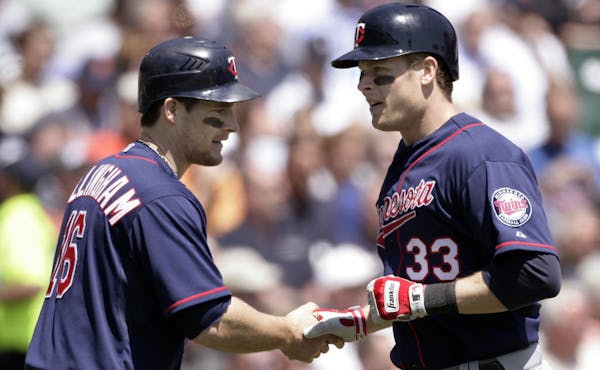 Justin Morneau (33) was congratulated by Josh Willingham (16) after hitting a two-run home run that scored the pair in the third inning Thursday.