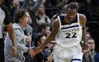 Minnesota Timberwolves forward Andrew Wiggins (22) high-fived a fan after scoring a 3-pointer against the Charlotte Hornets in the fourth quarter.