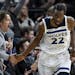 Minnesota Timberwolves forward Andrew Wiggins (22) high-fived a fan after scoring a 3-pointer against the Charlotte Hornets in the fourth quarter.