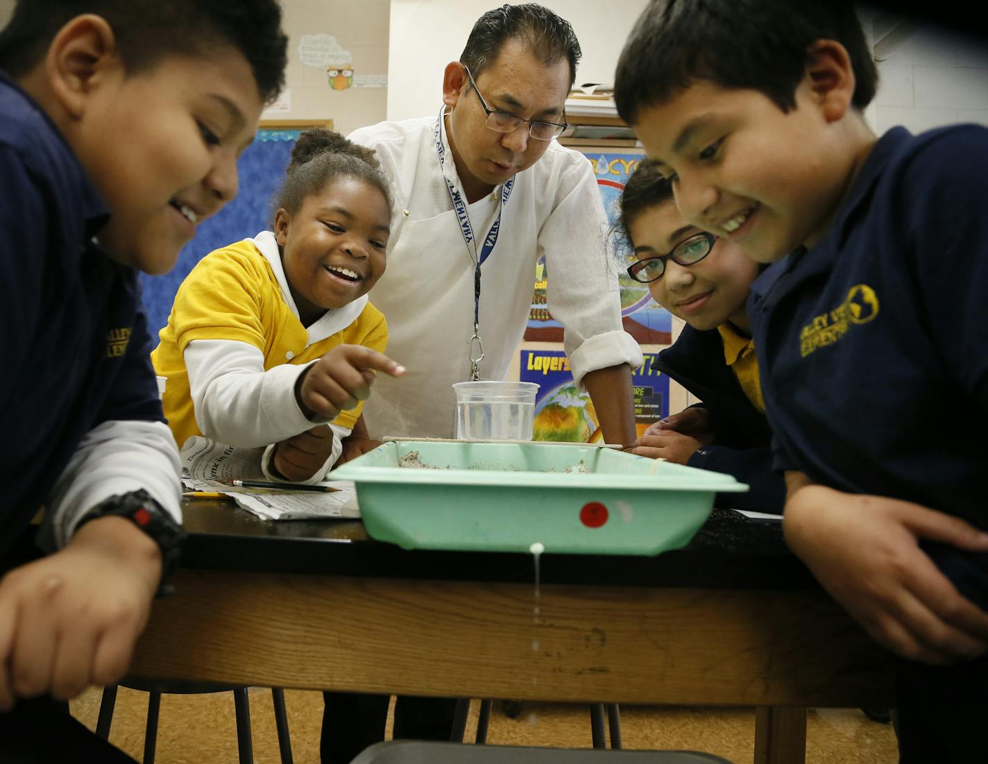 Namgyal Dorjee (center) a science teacher at Valley View elementary school worked with students left to right Moses Garcia, Selah Kirk, Emily Hodge, and Jonathan Pineda on an erosion project September 10 , 2014 in Columbia Heights , MN. Valley View Elementary stands out each year on the Star Tribune's Beating the Odds list - it is often the only non-charter school to make the list of schools that do very well on the MCA's despite crushing levels of poverty. ] Jerry Holt Jerry.holt@startribune.co