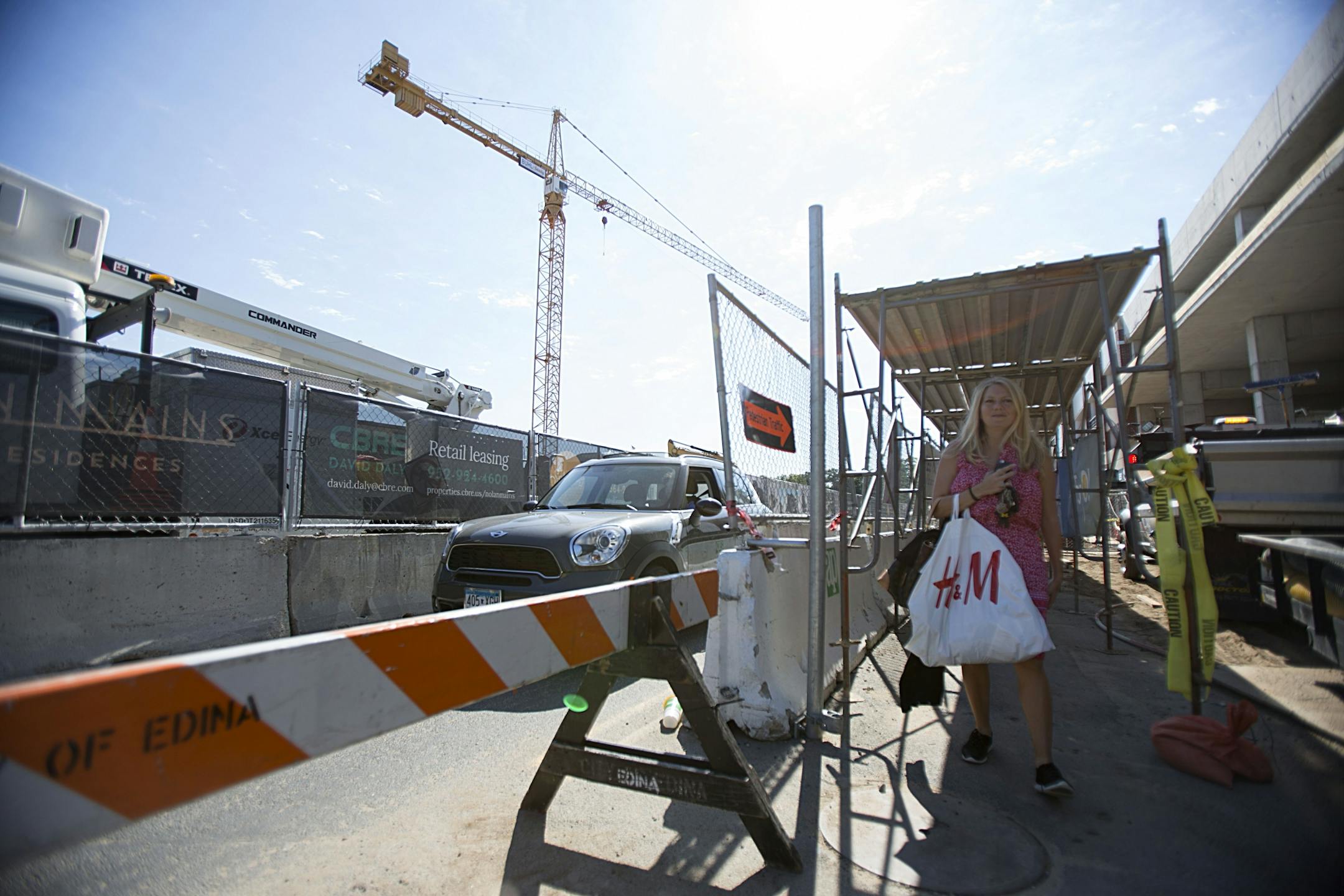 Susan Yost walks through the scaffolded pedestrian walkaway towards the shops.
