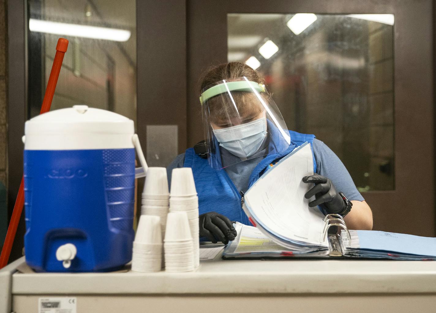 Health technician Kelsey Reeves flipped through her log of inmates while distributing medication to them on Tuesday at St. Louis County jail. ]
ALEX KORMANN &#x2022; alex.kormann@startribune.com The St. Louis County jail population has fallen dramatically as fewer arrests are made, which has helped keep a COVID-19 outbreak at bay inside the prison.