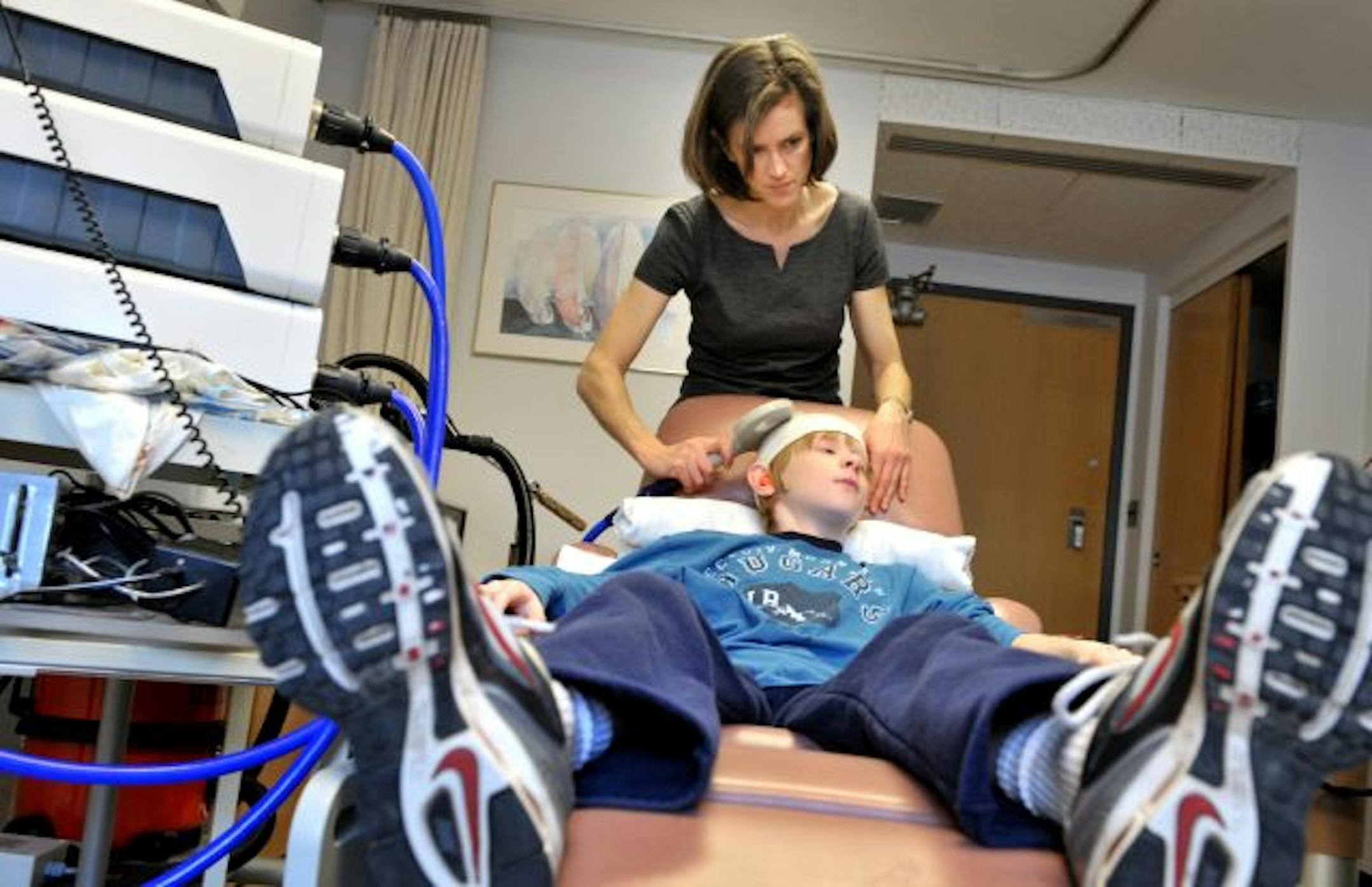Bernadette Gillick used a non-invasive magnetic stimulation wand to gather brain data on test subject Louis Barrett, 11. Gillick and researcher James Carey are running an NIH funded study to see if brain stimulation can help paralyzed children.