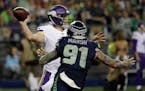 Case Keenum stepped up to make a throw with Seattle's Cassius Marsh rushing from the outside Friday night.