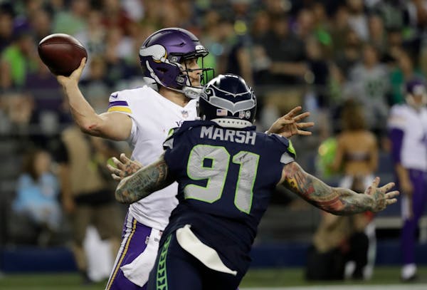 Case Keenum stepped up to make a throw with Seattle's Cassius Marsh rushing from the outside Friday night.