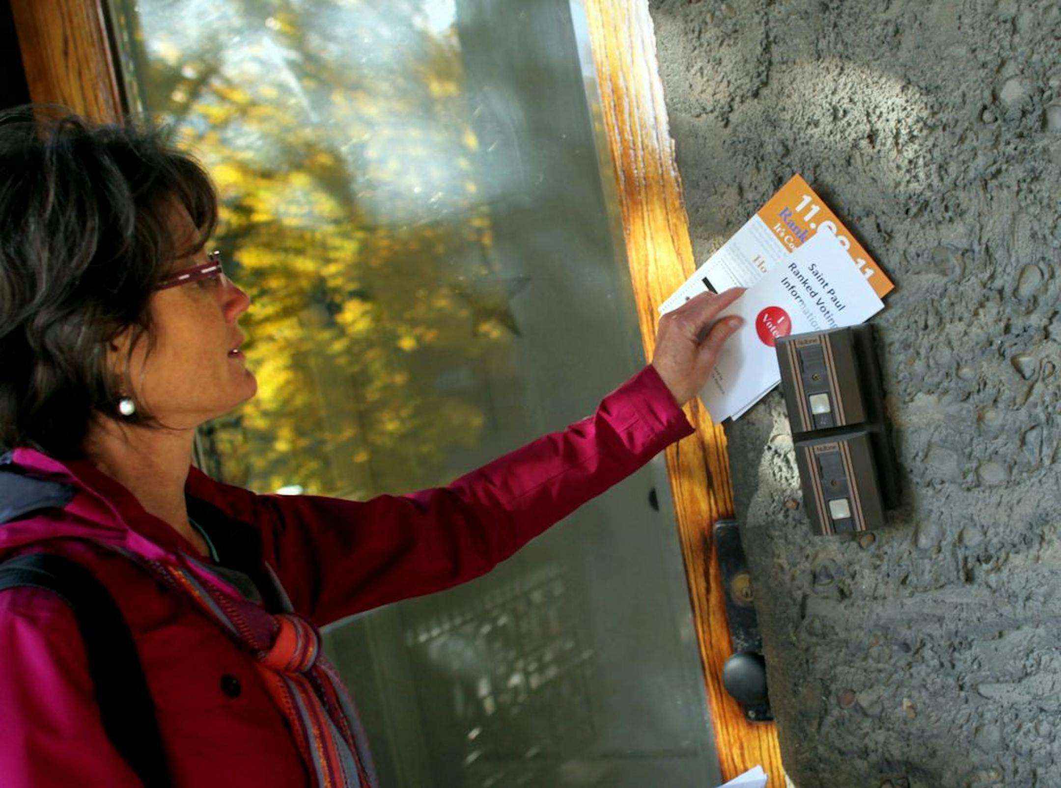 Jeanne Massey put information at a St. Paul resident's home about St. Paul's new rank voting procedure as she walked from door to door on behalf of FairVote Minnesota in St. Paul, Minn., Monday, November 7, 2011.