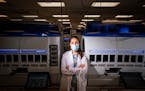 Dr. Elitza Theel posed for a photo in Mayo Clinic's Infectious Disease Serology Laboratory in Rochester. Behind her is the automated testing platform 