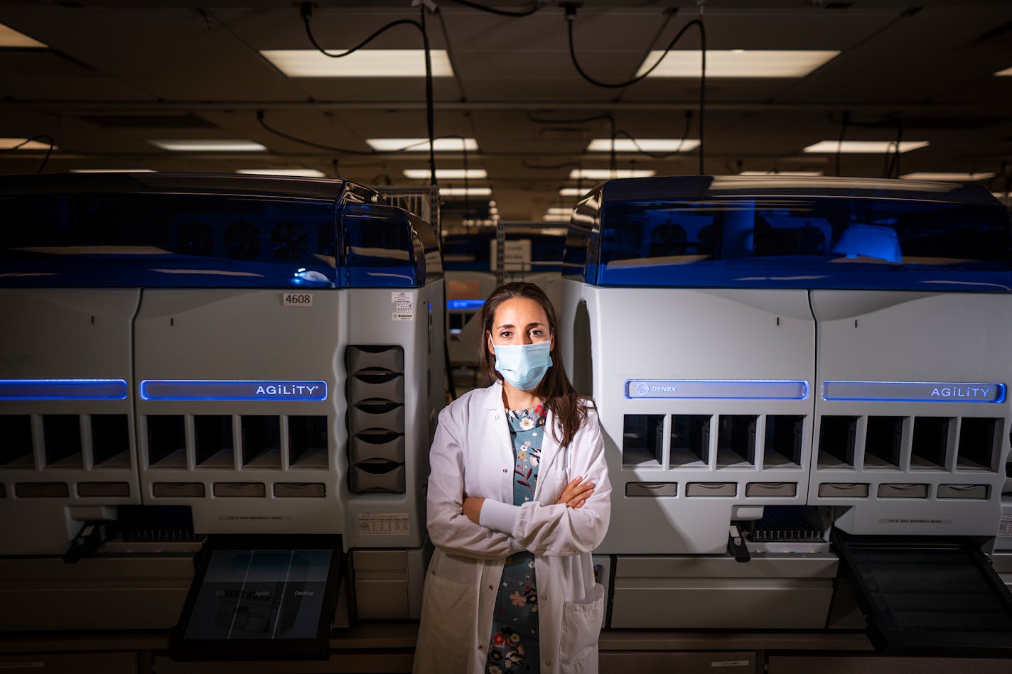 Dr. Elitza Theel posed for a photo in Mayo Clinic's Infectious Disease Serology Laboratory in Rochester. Behind her is the automated testing platform which performs serologic testing to identify past exposure and potential immune response to SARS-CoV-2, the virus that causes COVID-19.