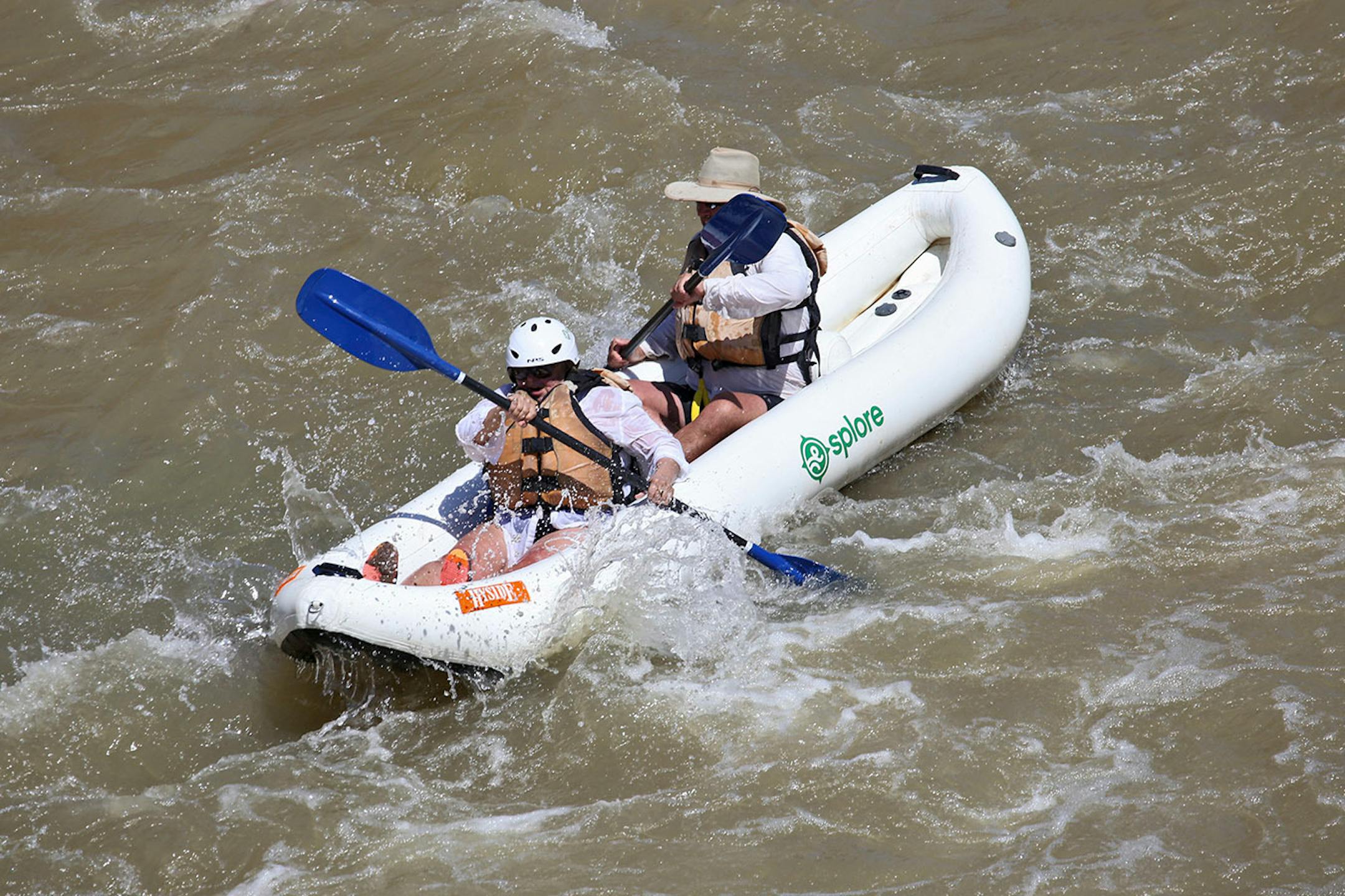 Mary Buchta (bow) and Jim Buchta (stern) navigate the Class II-III Salt Wash rapids along the east border or Arches National Park. These were last rapids during our 15 or so-mile river trip.