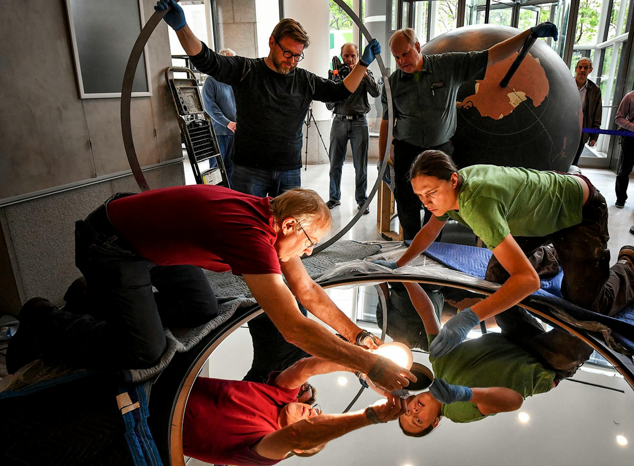 Workers from Blue Rhino Studio in Eagan handled the restoration and placement of the Star Tribune globe.