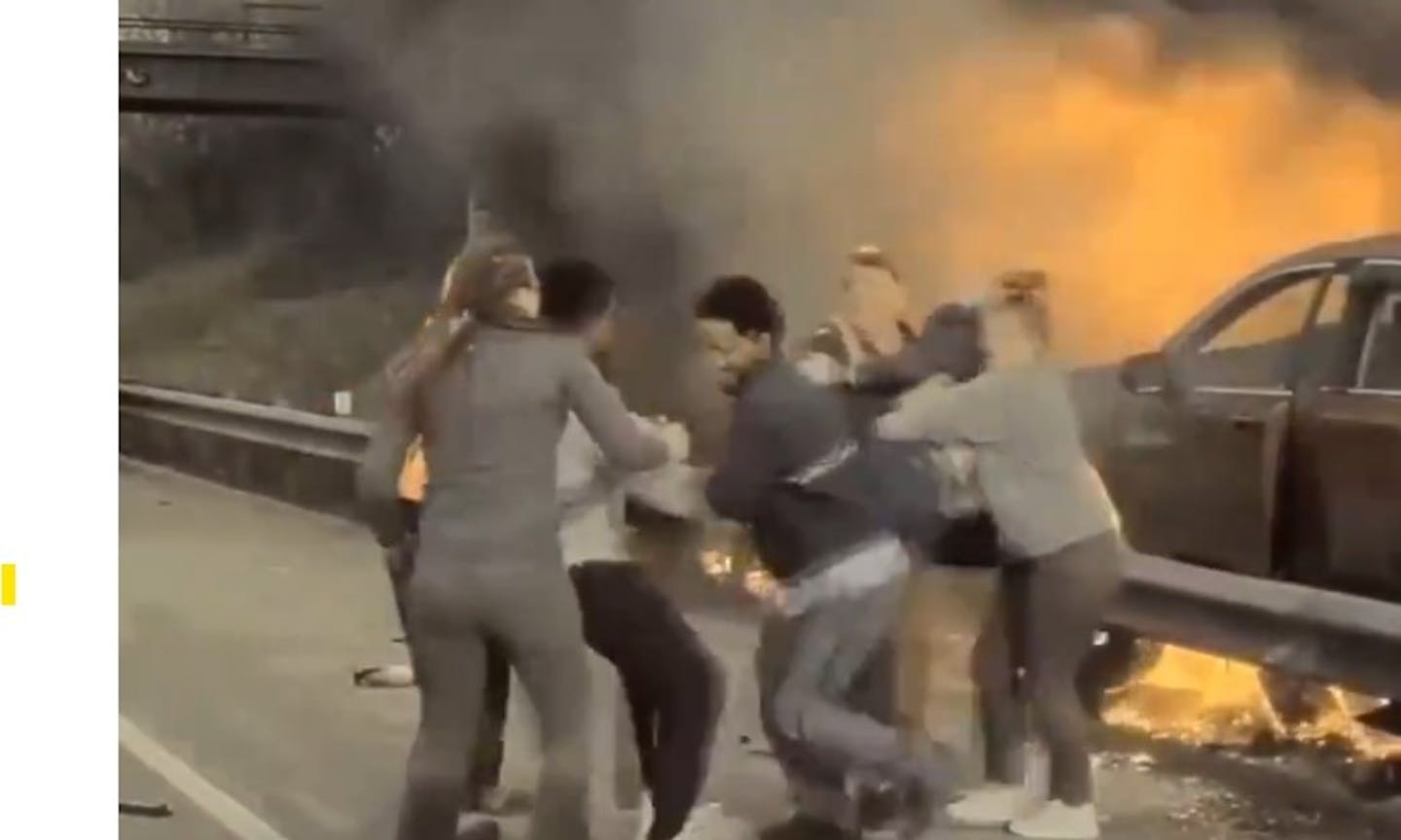 Good Samaritans rescue a driver from his burning SUV on Interstate 94 in St. Paul on Thursday.