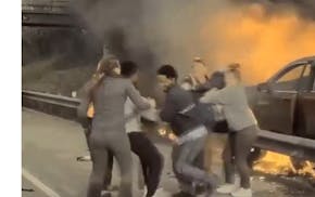 Good Samaritans rescue a driver from his burning SUV on Interstate 94 in St. Paul on Thursday.