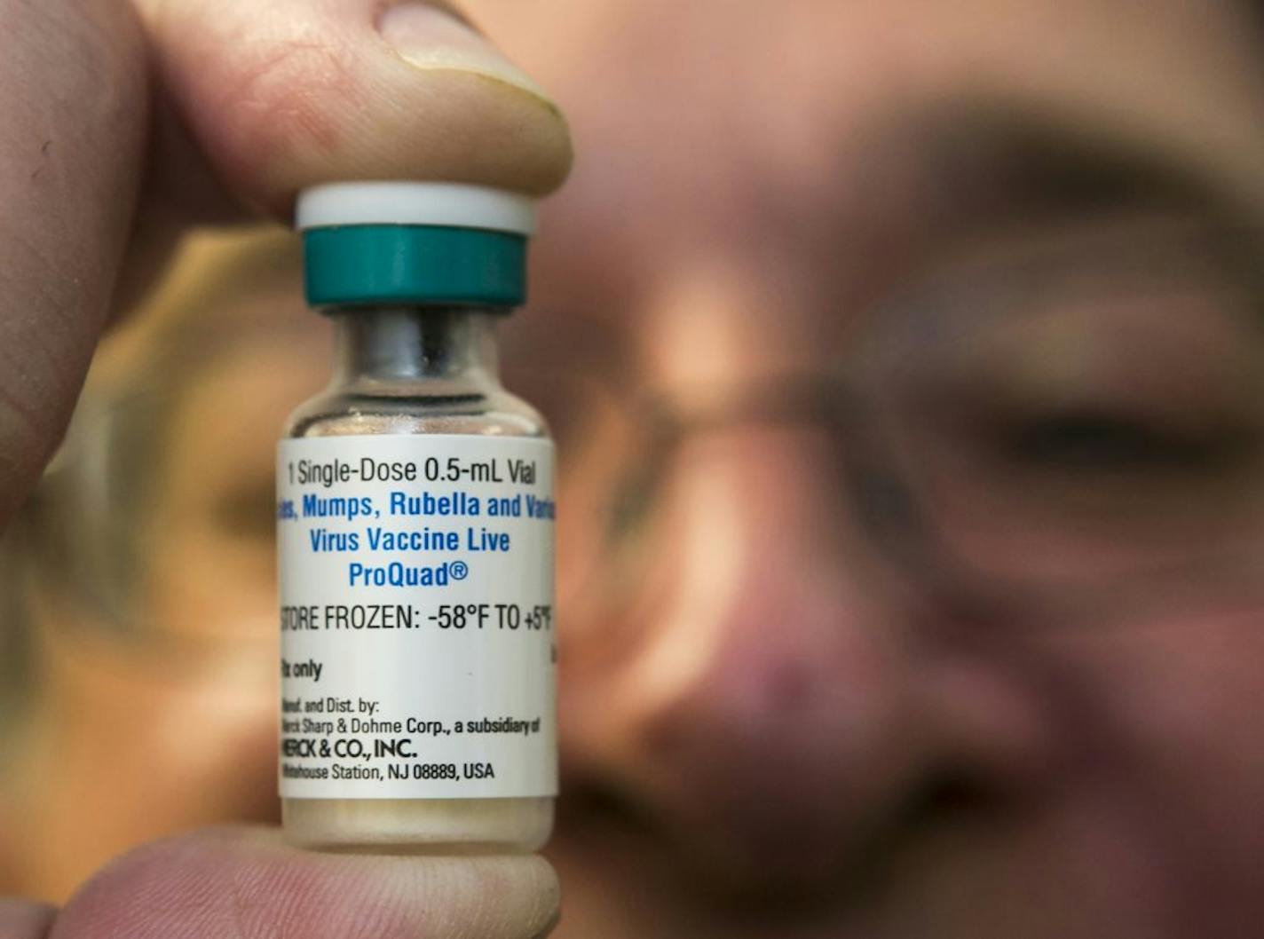 FILE - In this Thursday, Jan. 29, 2015 file photo, a pediatrician holds a dose of the measles-mumps-rubella (MMR) vaccine at his practice in Northridge, Calif. In 2014, only 21 states posted vaccination rates for individual schools, school districts, counties or areas of the state. The Centers for Disease Control and Prevention has been quietly prodding more states to make the information available. On Thursday, Aug. 27, 2015, the CDC's Dr. Anne Schuchat made the push more public during a news c