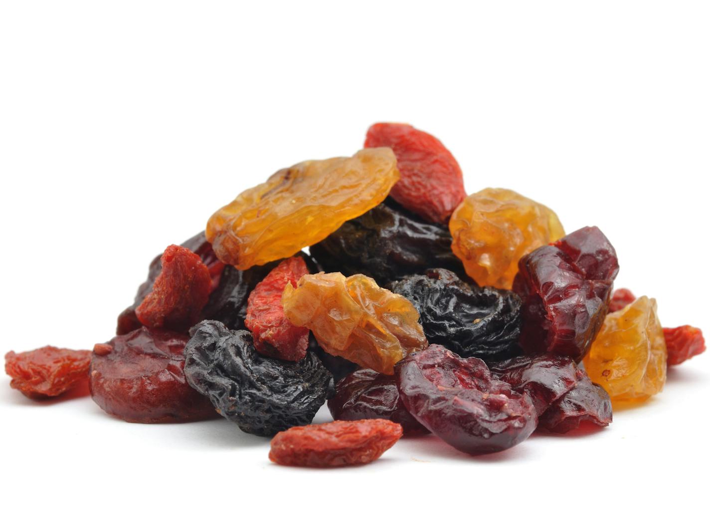 "A close up shot of a pile of dried bluberries, cherries, cranberries, goji and raisins isolated on white."