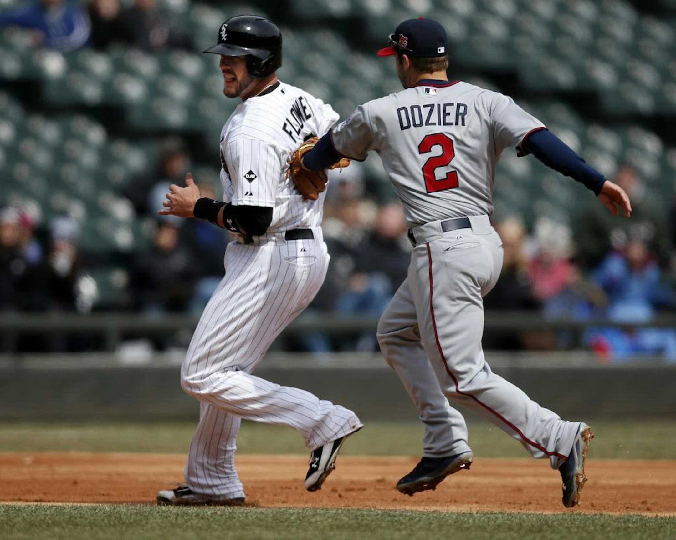 Chicago White Sox catcher Tyler Flowers is tagged out by Minnesota Twins second baseman Brian Dozier during the second inning of a baseball game on Wednesday, April 2, 2014, in Chicago, Ill.