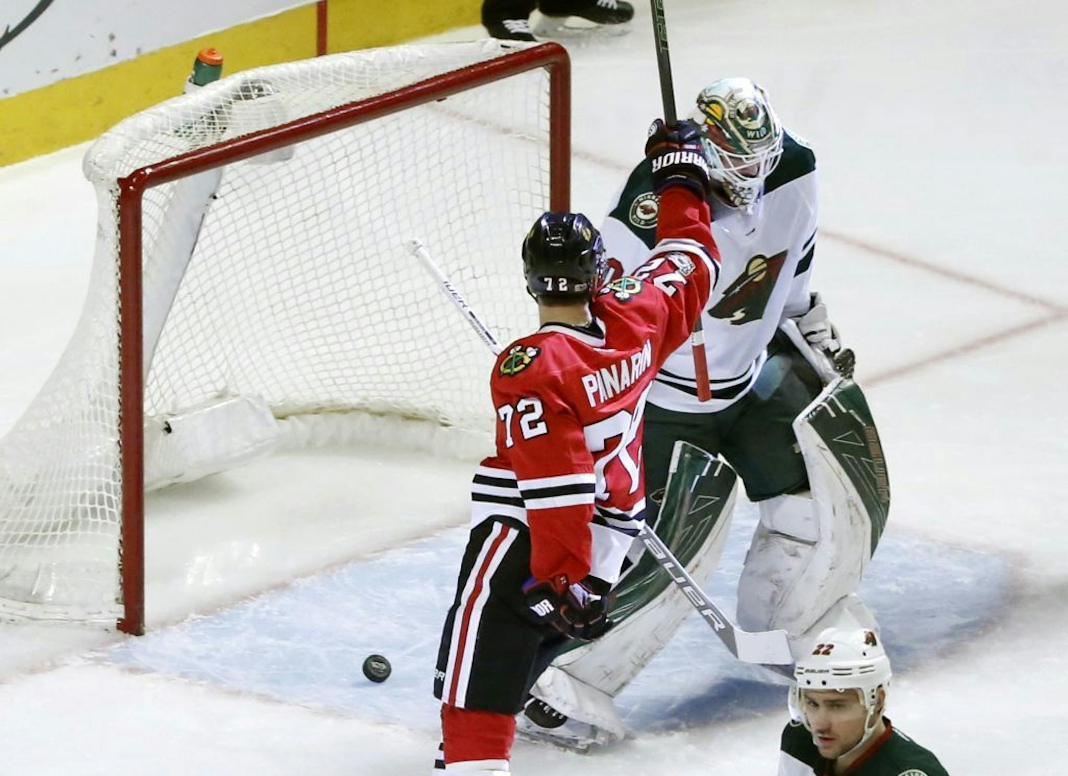 Chicago Blackhawks' Artemi Panarin (72) looks at Minnesota Wild's Devan Dubnyk, as Panarin celebrates his goal during the first period of an NHL hockey game Sunday, March 12, 2017, in Chicago.