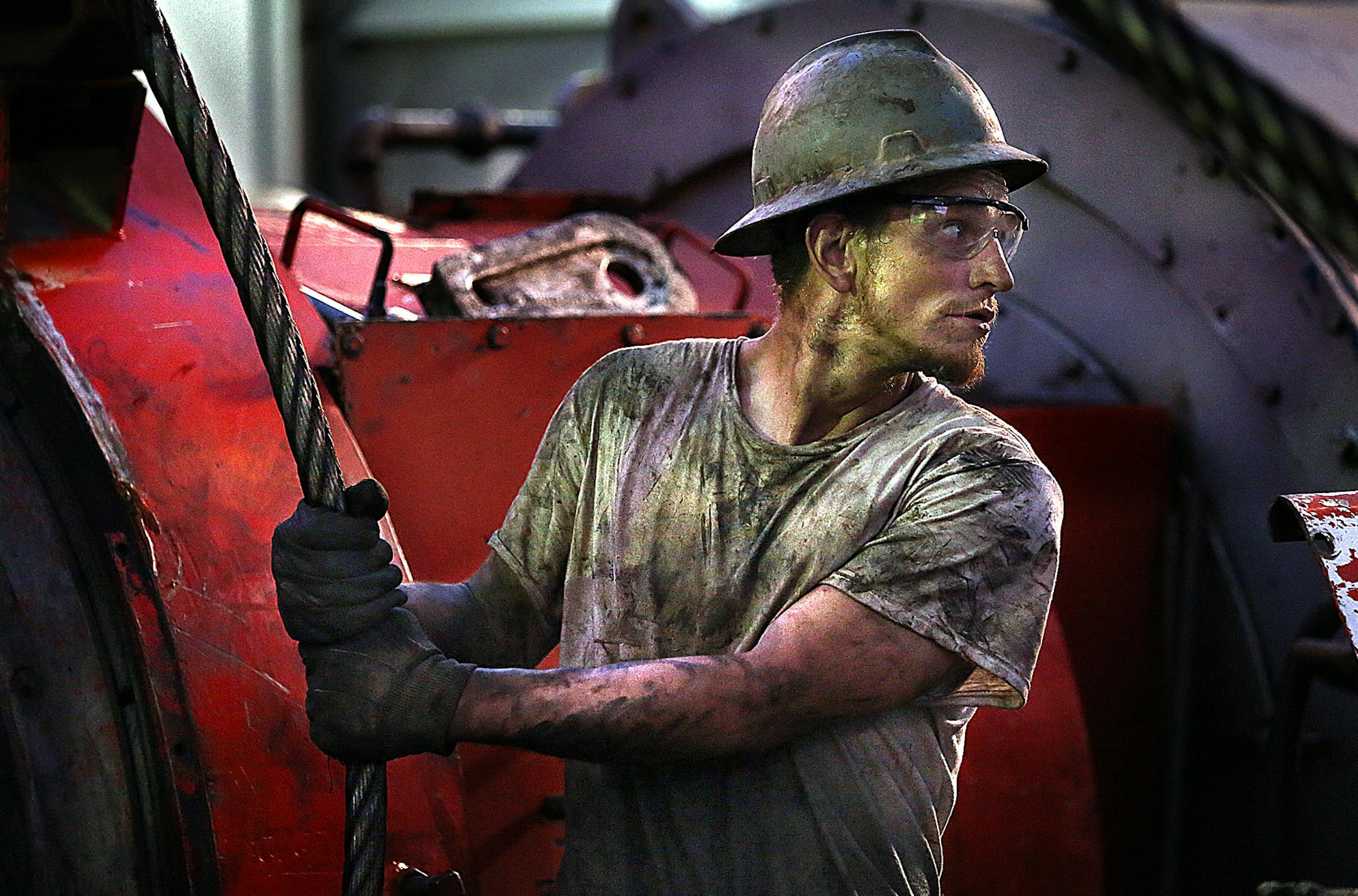 Floor hand Ray Gerrish worked to make repairs on a drilling rig as the sun rose near the site outside Watford City.