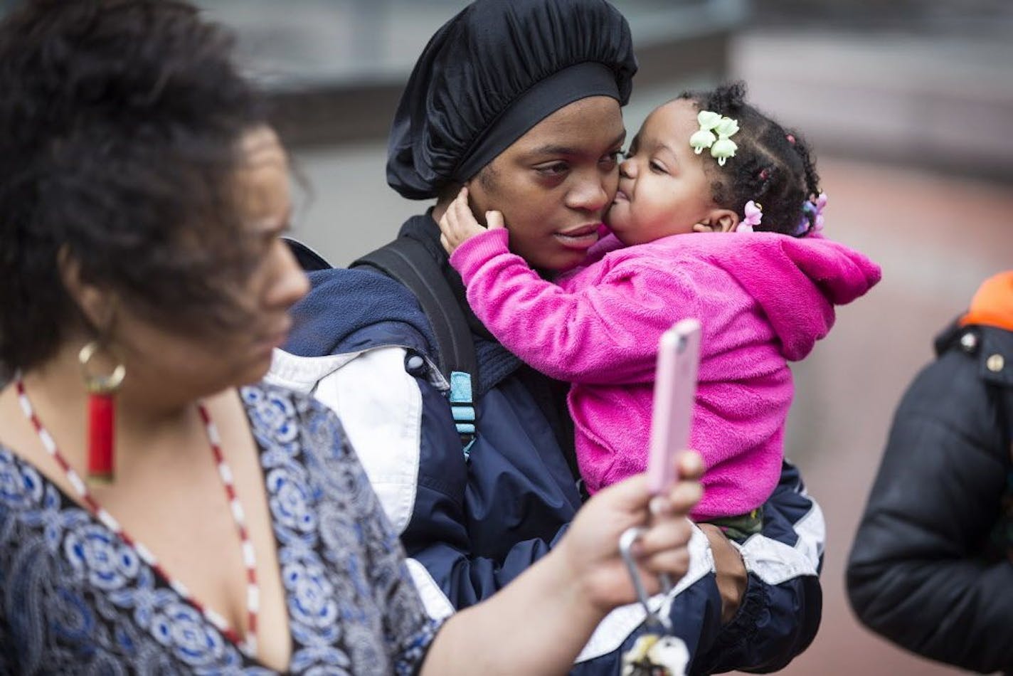 Plaintiff Shyntoria Johnson and her daughter Yunique, 1, gathered with others outside the Hennepin County Courthouse during a press conference announcing a lawsuit against the state of Minnesota for allowing segregation in schools in downtown Minneapolis on Thursday, November 5, 2015.