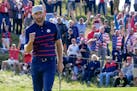 Team USA's Dustin Johnson reacts after winning the 11th hole during a four-ball match at the Ryder Cup