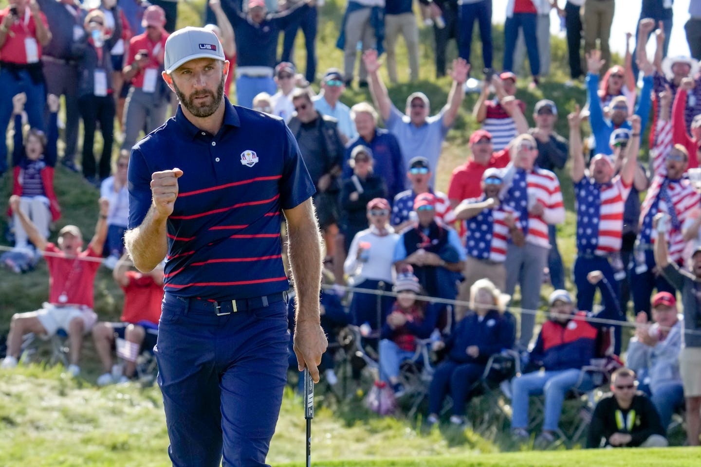 Team USA's Dustin Johnson reacts after winning the 11th hole during a four-ball match at the Ryder Cup