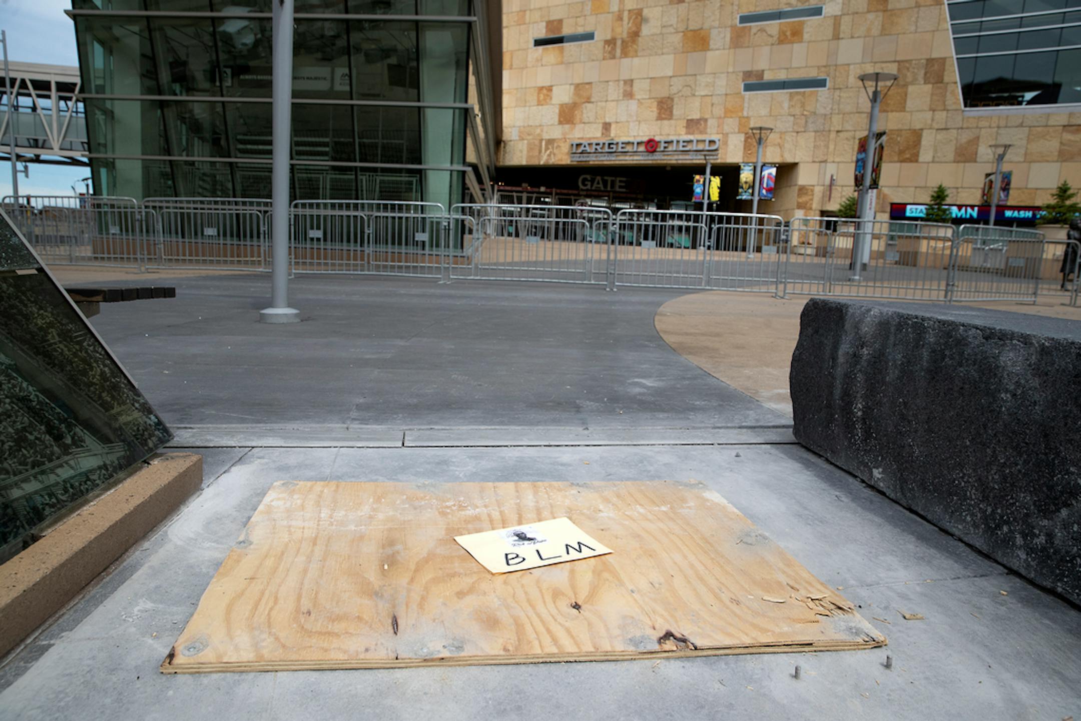 Plywood marks the spot where a statue of former Minnesota Twins owner Calvin Griffith stood outside Target Field, Friday, June 19, 2020, in Minneapolis, Minn. The baseball club announced Friday that they removed the statue, citing racist remarks Griffith made in 1978. (Elizabeth Flores/Star Tribune via AP)