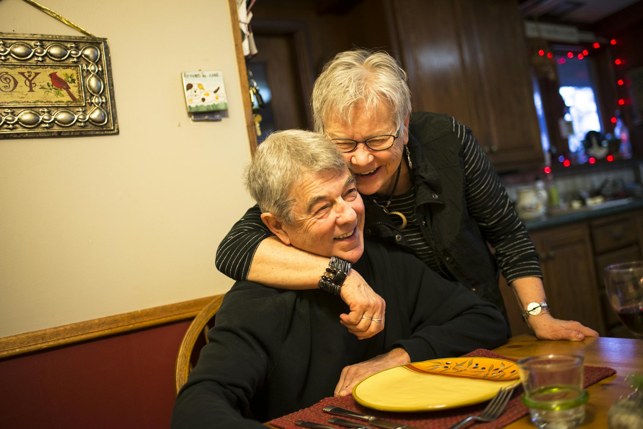 Joni Grosso embraced Lorne as the two sat down for lunch in their home in mid-December. ] (AARON LAVINSKY/STAR TRIBUNE) aaron.lavinsky@startribune.com Mayo boys hockey coach Lorne Grasso was photographed in his home and at Graham Arena on Thursday, Dec. 10, 2015 in Rochester, Minn.