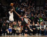 The Timberwolves' Anthony Edwards, who had been slumping from long distance, hits a three-pointer over the Raptors' Immanuel Quickley during the first