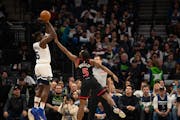 The Timberwolves' Anthony Edwards, who had been slumping from long distance, hits a three-pointer over the Raptors' Immanuel Quickley during the first