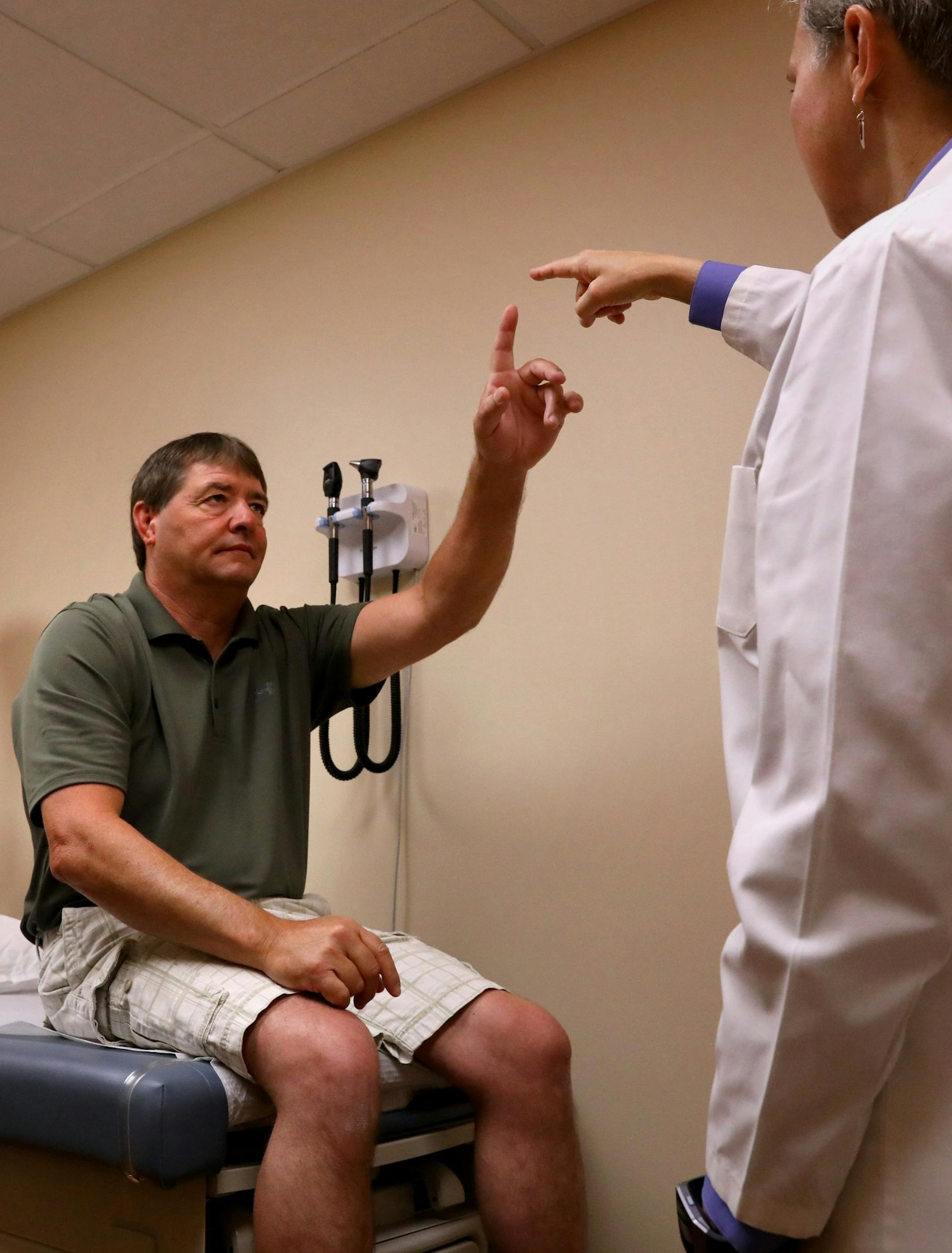 Dean DeMoe, left, takes a neural exam on Thursday, May 31, 2018, with Barbara Snider, an investigator with Washington University School of Medicine's study of people living with dominantly inherited Alzheimer's disease. DeMoe, of Williams County, N.D., comes to the Knight Alzheimer's Disease Research Center once a year to undergo testing for researchers as part of the study. (Christian Gooden/St. Louis Post-Dispatch/TNS)