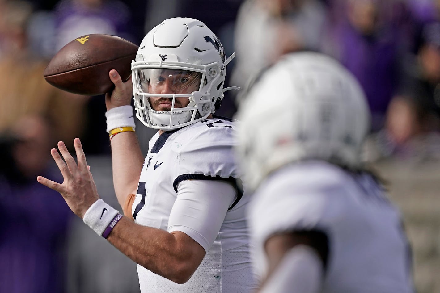 West Virginia quarterback Jarret Doege throws during the first half of an NCAA college football game against Kansas State, Saturday, Nov. 13, 2021, in Manhattan, Kan. (AP Photo/Charlie Riedel)