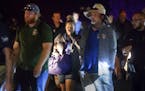 Police officers escort people from Christmas Hill Park following a deadly shooting during the Gilroy Garlic Festival, in Gilroy, Calif., on Sunday, Ju