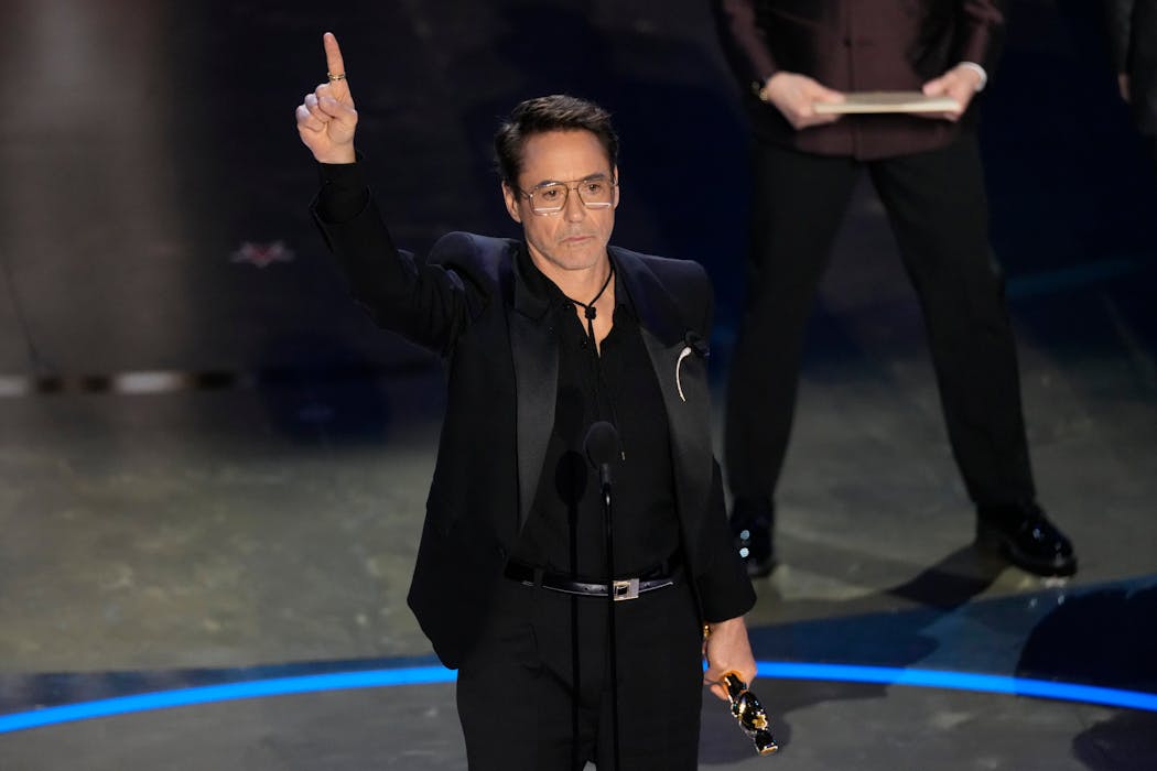 Robert Downey Jr. accepts the award for best performance by an actor in a supporting role for 