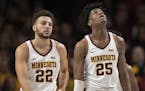 Gophers guard Gabe Kalscheur (22) and center Daniel Oturu looked up at the scoreboard after a crucial missed free throw late in the second half agains