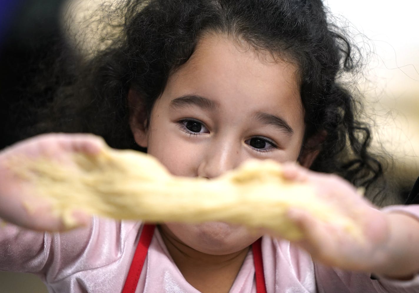 Eliana Mammadov, 4, of Plymouth kneaded her challah dough during the Great Big Challah Bake. ] LEILA NAVIDI &#x2022; leila.navidi@startribune.com BACKGROUND INFORMATION: More than 500 women and girls participates in the Great Big Challah Bake at Hopkins High School in Minnetonka on Thursday, November 14, 2019.