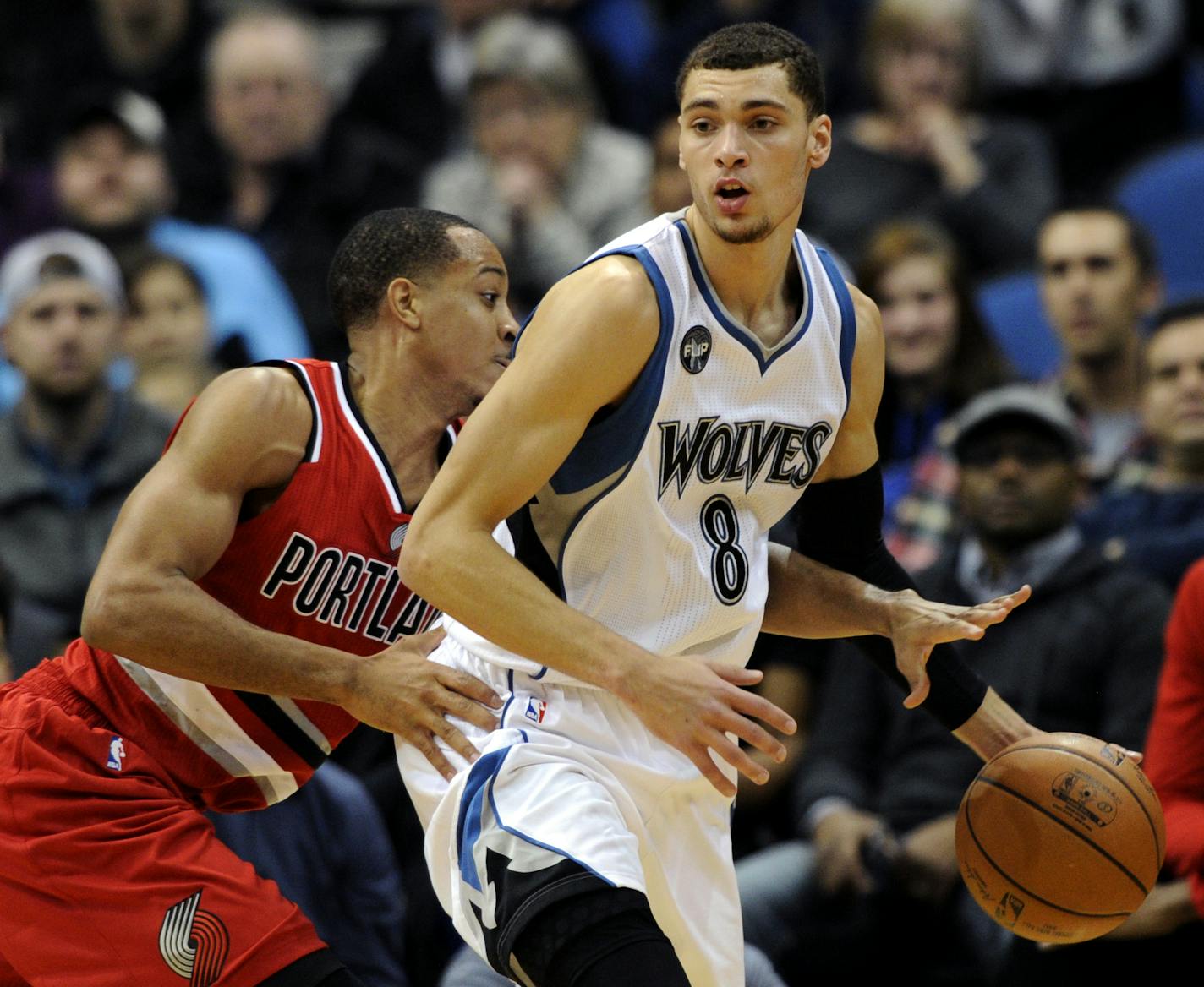 Portland Trail Blazers guard C.J. McCollum, left, knocks the ball away from Minnesota Timberwolves guard Zach LaVine.