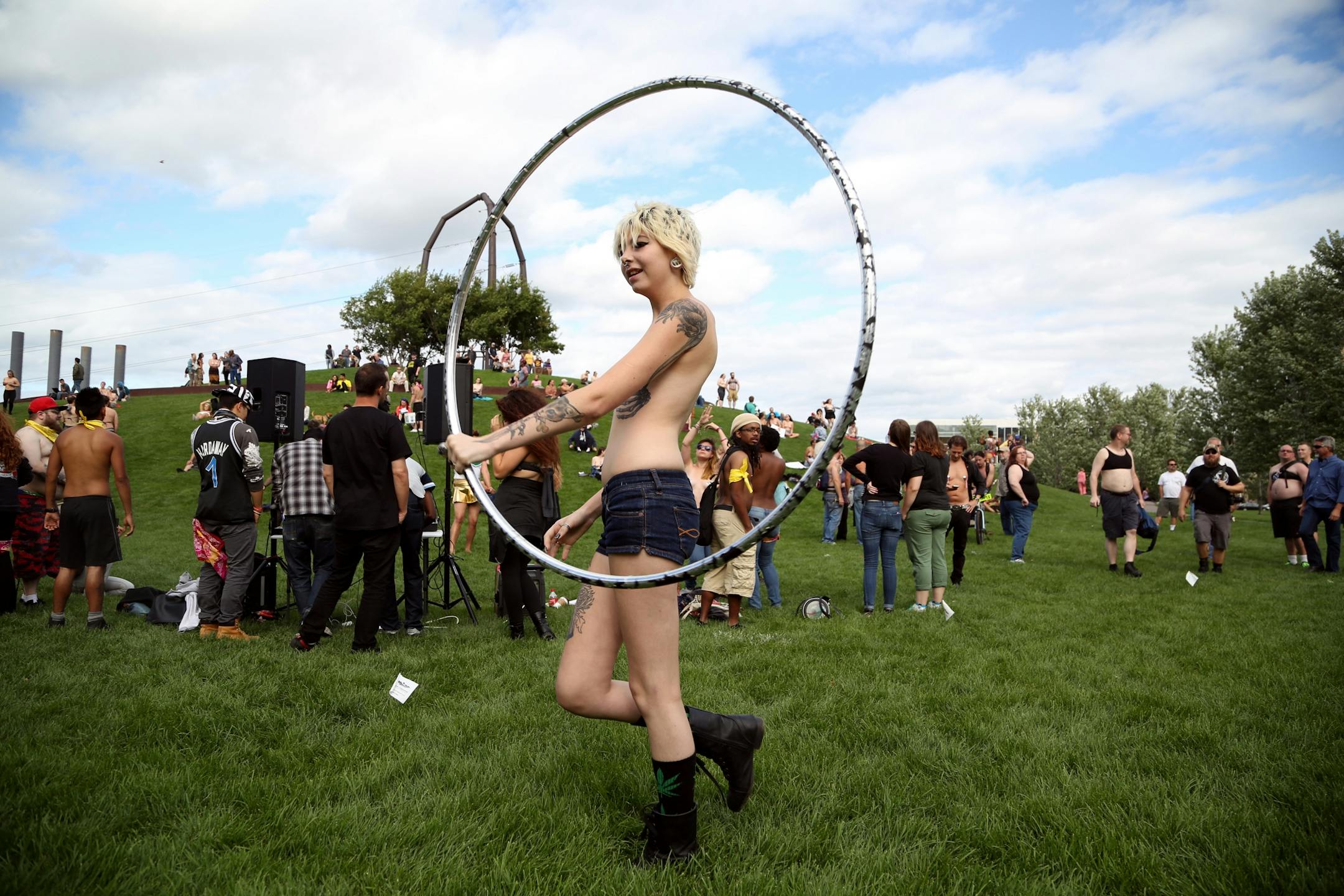 Randi Legato danced topless saying it's a matter of gender equity and freedom of expression during a demonstration at Gold Medal Park Sunday August 23, 2015 in Minneapolis, MN.