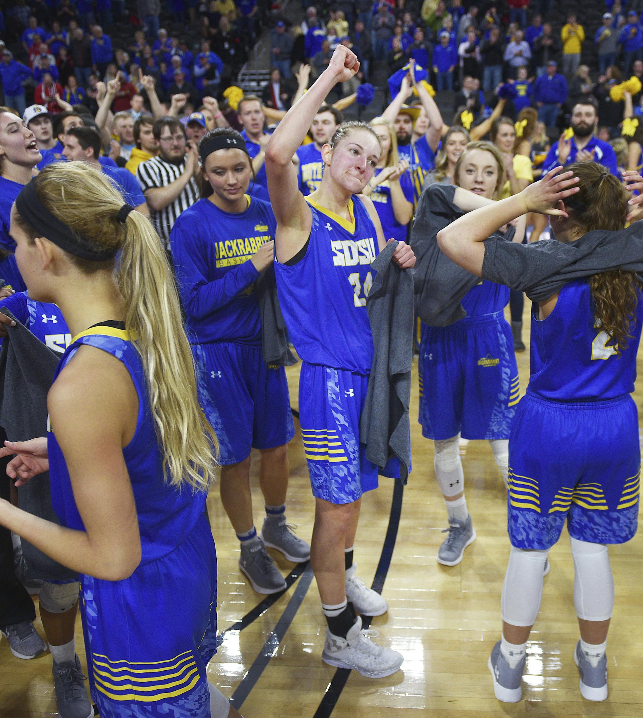 South Dakota State players celebrate a 65-50 win over South Dakota in an NCAA college basketball game Tuesday, March 6, 2018, in the Summit League women's tournament final in Sioux Falls, S.D. (Briana Sanchez/The Argus Leader via AP)