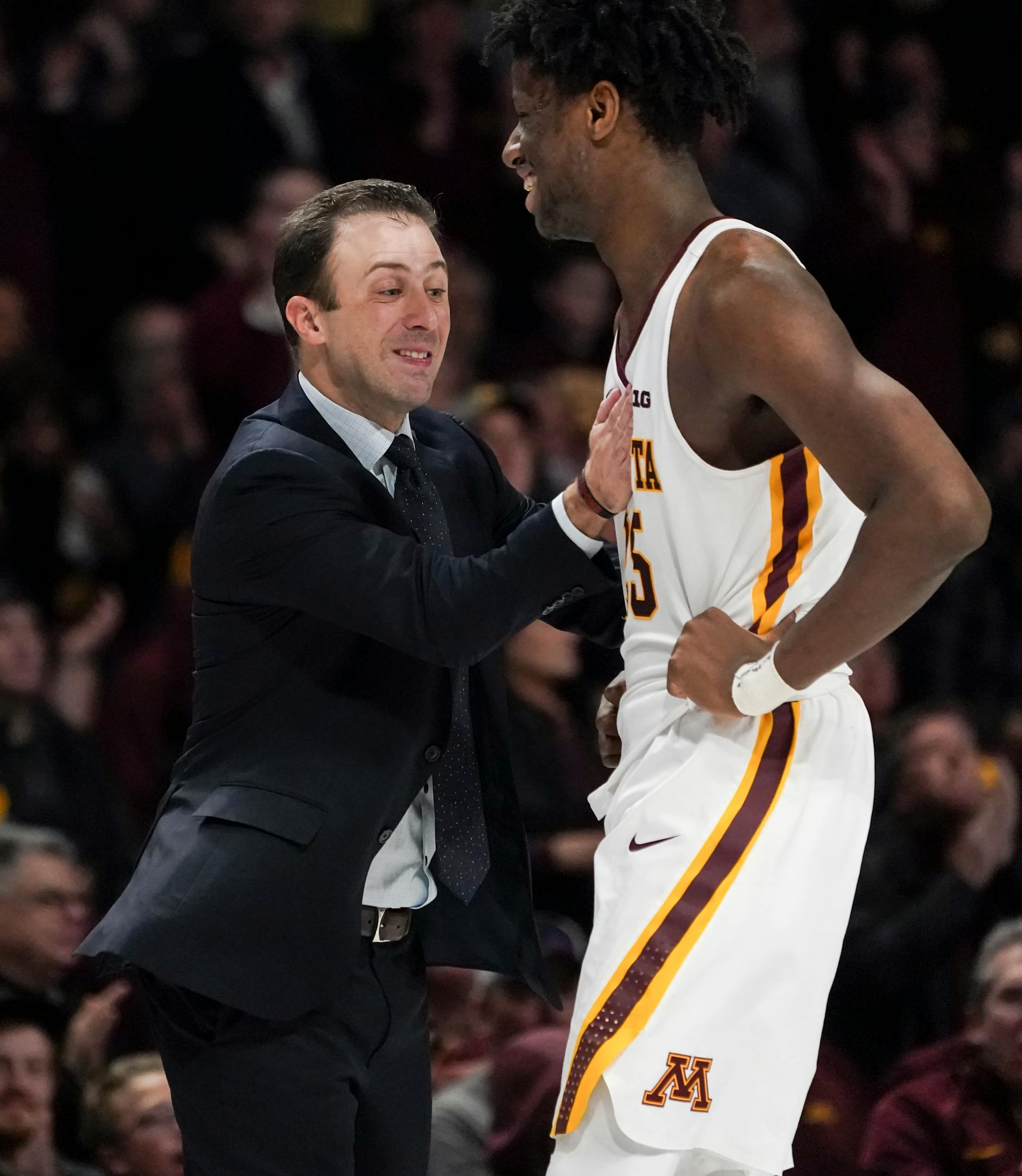 Minnesota Gophers coach Richard Pitino patted Minnesota Gophers center Daniel Oturu (25) on the chest at the beginning of a time out after tour made an important basket to take the lead in the second half against Penn State on January 15, 2020.