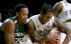 Miami's Kenny Kadji, left, reaches for a rebound against Georgia Tech's Marcus Georges-Hunt in the first half of an NCAA college basketball game, Satu