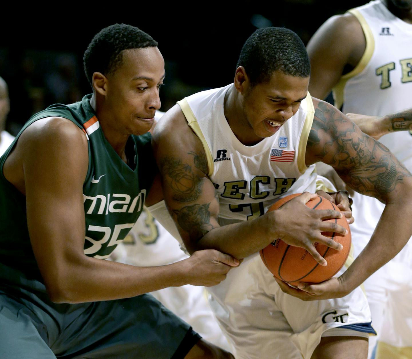 Miami's Kenny Kadji, left, reaches for a rebound against Georgia Tech's Marcus Georges-Hunt in the first half of an NCAA college basketball game, Saturday, Jan. 5, 2013, in Atlanta. (AP Photo/David Goldman) ORG XMIT: GADG113