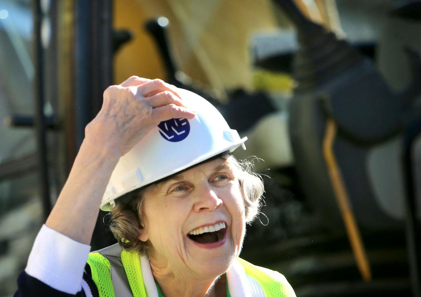 Sharing and Caring Hands founder Mary Jo Copeland helped tear down the building that housed her dream for 30 years Thursday, April 23, 2015 in Minneapolis, MN. The demolition is making way for an expansion of the daycare and teen center and will bring the number of rooms for homeless families from 92 to 100. Here, Copeland smiled for admirers and onlookers after operating the backhoe.](DAVID JOLES/STARTRIBUNE)djoles@startribune.com The building that has housed Sharing and Caring Hands for more t