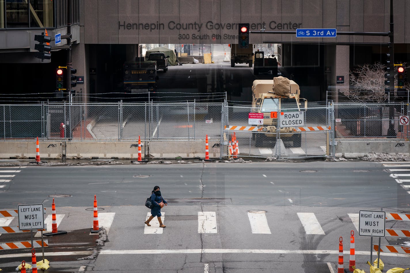 A pedestrian crossed the street outside the heavily fortified Hennepin County Government Center. ] LEILA NAVIDI • leila.navidi@startribune.com