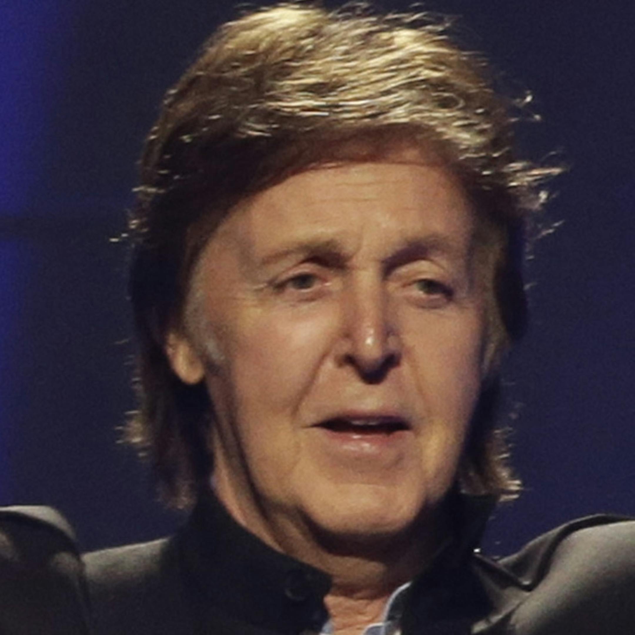 FILE - In this Saturday, May 18, 2013 file photo, Paul McCartney performs during the first U.S concert of his "Out There" tour, in Orlando, Fla. McCartney made his first visit to the one-time home of the King of Rock 'N' Roll and left a gift behind. According to the official Twitter account of the former Beatle, McCartney dropped a personal guitar pick on Elvis Presley's grave, Sunday, May 26, 2013, and said it was ìso Elvis can play in heaven." (AP Photo/John Raoux, File)