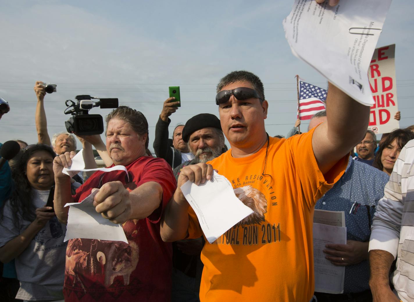 Arthur LaRose, secretary treasurer of Leach Lake Band of Ojibwa and chairman of the 1895 Treaty Board, right, and Steven Clark, vice chair of the board, ripped up the one-day use permit from the DNR on Thursday.