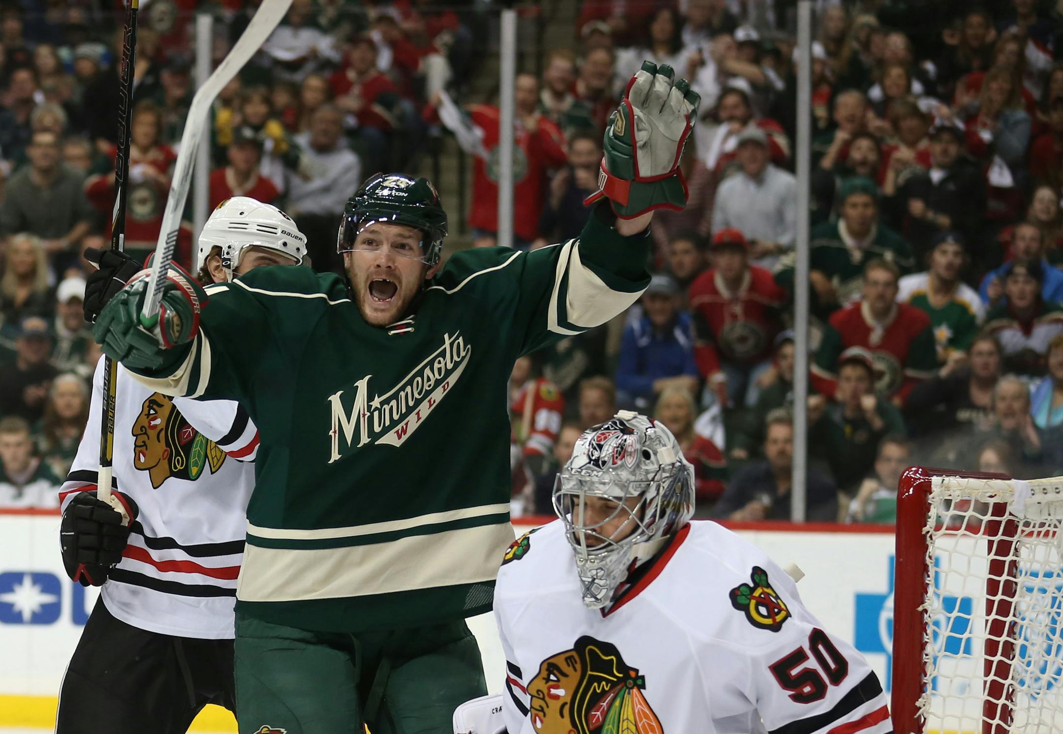 Minnesota Wild left wing Matt Cooke (24) celebrated after the Wild scored during first period action.