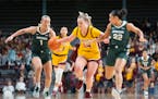 Gophers forward Mallory Heyer was pressured by Michigan State guards Tory Ozment (1) and Moira Joiner (22) in the third quarter Saturday.