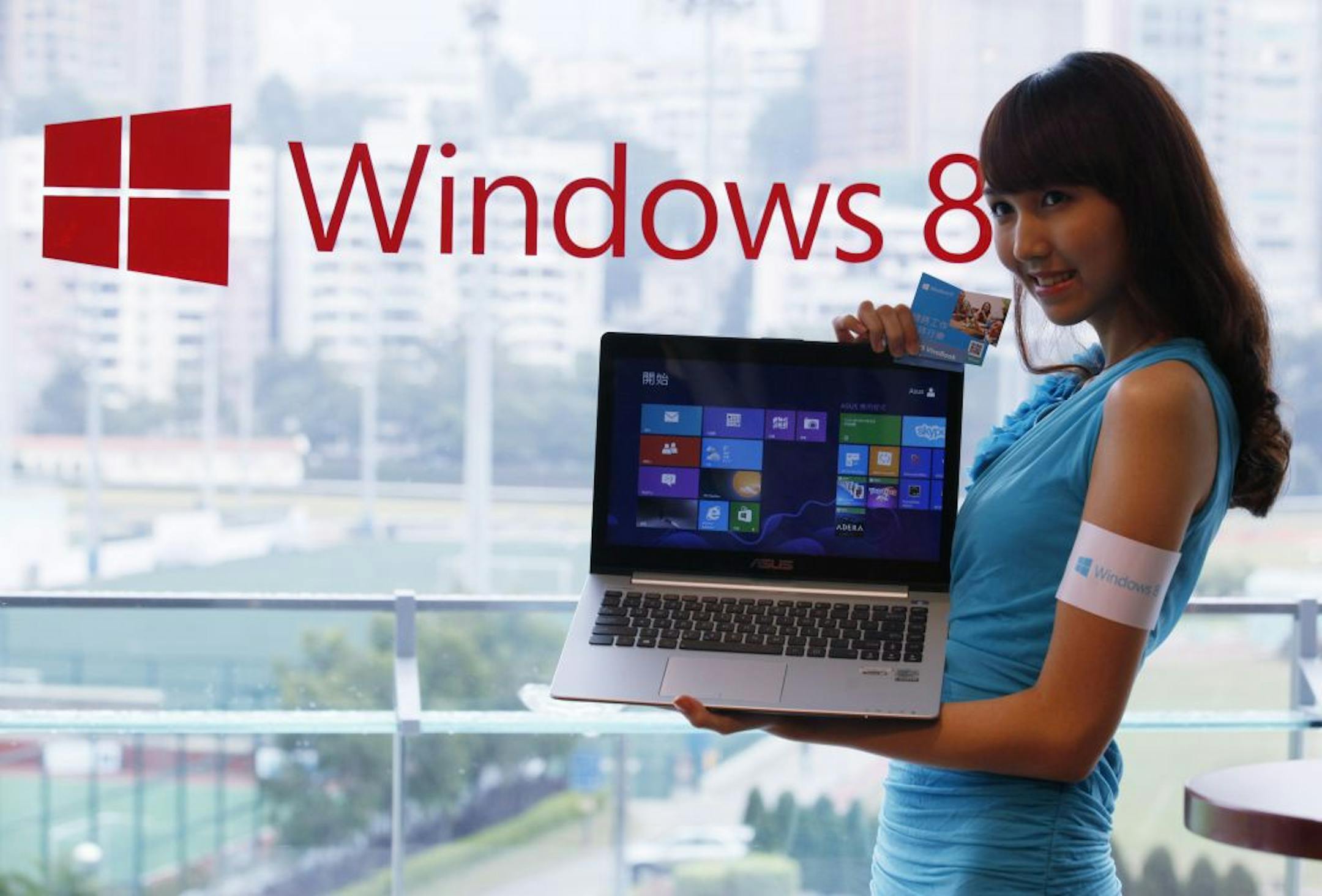 A model displays a laptop computer running Microsoft Windows 8 operating system during a launching ceremony in Hong Kong Friday, Oct. 26, 2012. Microsoft launched a radical redesign of its world-dominating Windows operating system, introducing a touch-enabled interface that attempts to bridge the gap between personal computers and fast-growing mobile devices powered by the company's fiercest competitors.