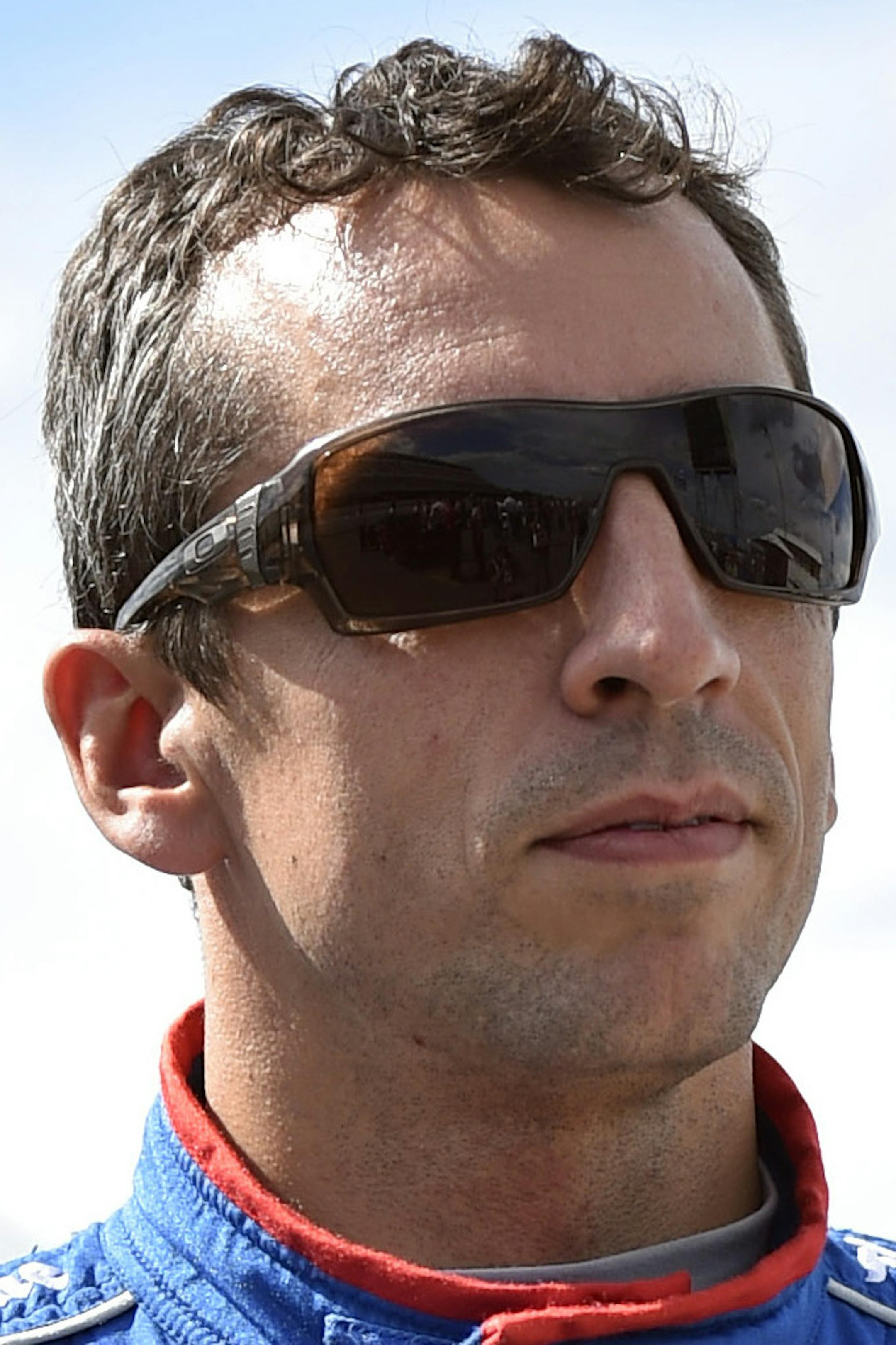 Justin Wilson, of England, walks on pit road during qualifying for Sunday's Pocono IndyCar 500 auto race, Saturday, Aug. 22, 2015, in Long Pond, Pa. Wilson was injured during Sunday's race and air lifted to the hospital. (AP Photo/Derik Hamilton)