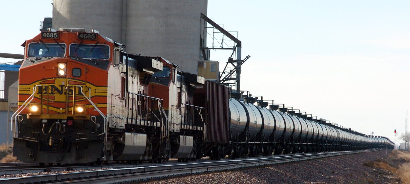 FILE - This Nov. 6, 2013, file photo, shows a BNSF Railway train hauling crude oil near Wolf Point, Mont. Railroads that haul volatile crude shipments have reached an agreement with U.S. transportation officials to adopt wide-ranging voluntary safety measures after a string of explosive and deadly accidents. (AP Photo/Matthew Brown, File)