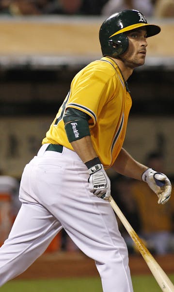 Oakland Athletics' Sam Fuld strikes out with two runners on base during the seventh inning of a baseball game against the Kansas City Royals, Friday, 
